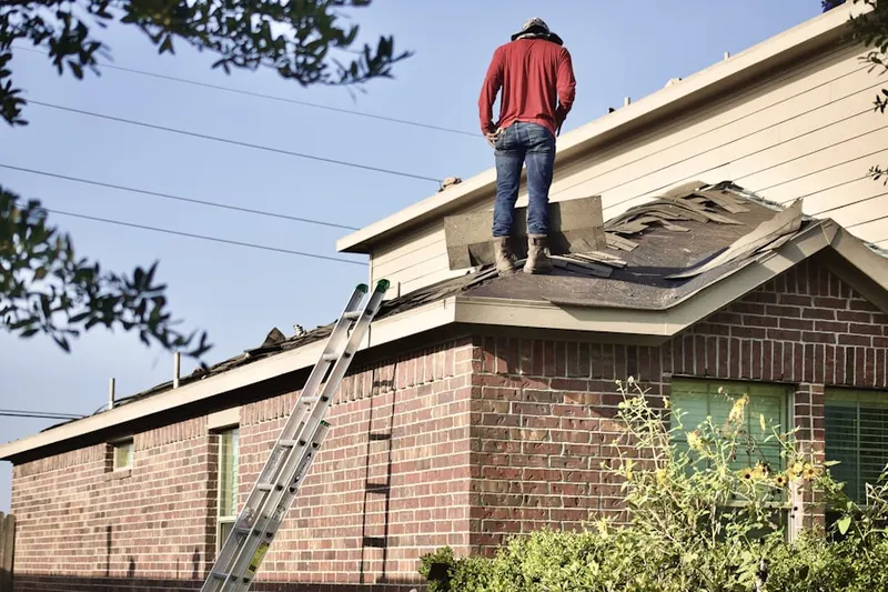 Professional roofer working on a residential roof in Newark Central Business District